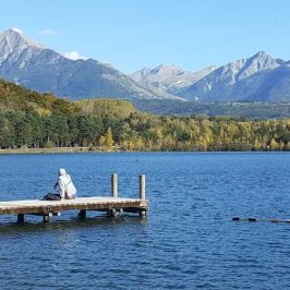 plan d'eau de saint-bonnet-en-Champsaur embarcadère et homme et montagnes en fond